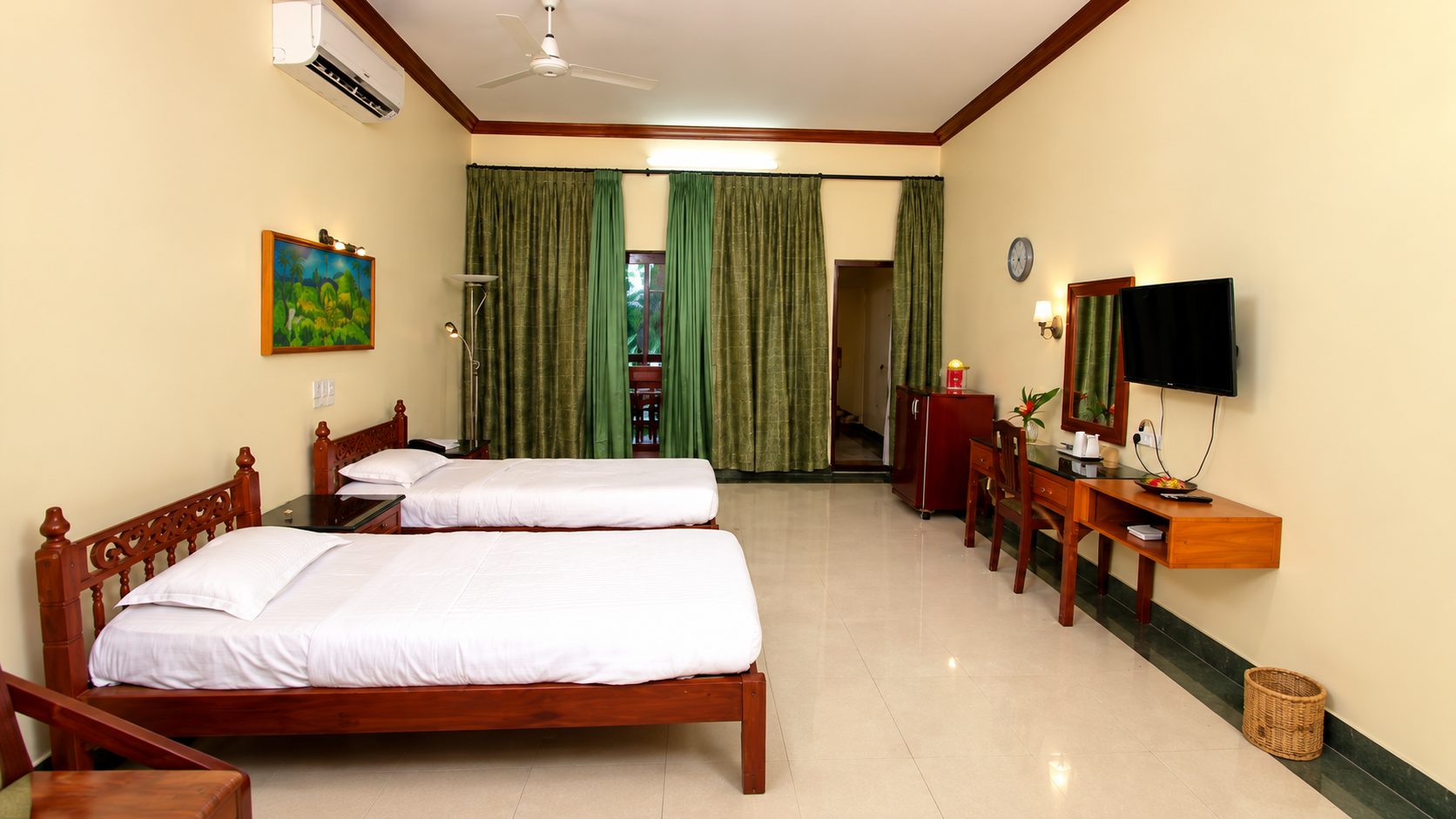A Standard Room with twin carved wooden beds and garden views